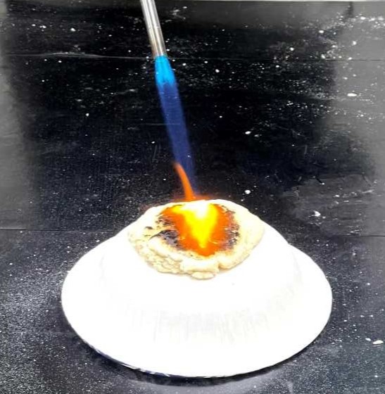 Blow torch hitting dough in lab experiment