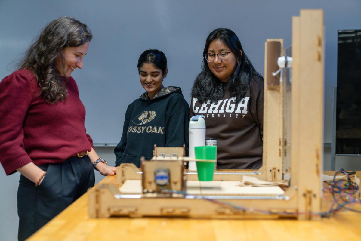 Professor Christina Haden observes project with Zonia Fatima (left) and Sheila Hernandez (right)