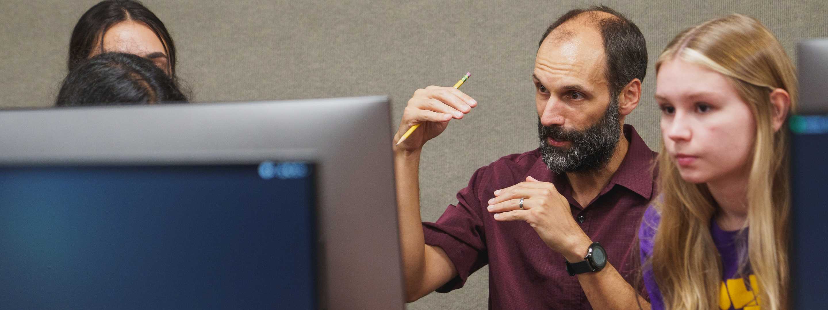 Prof. Spear teaches computer science to a female student