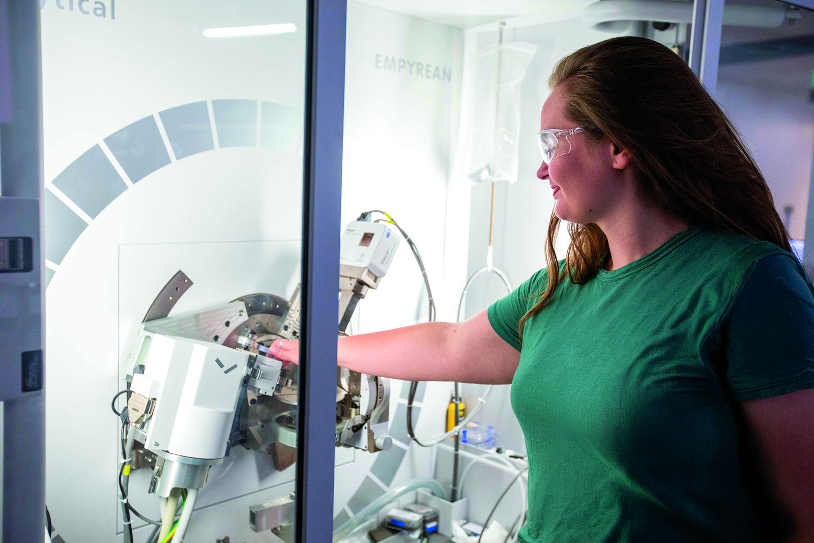 A Lehigh materials science researcher loading a sample into an X-ray diffractometer