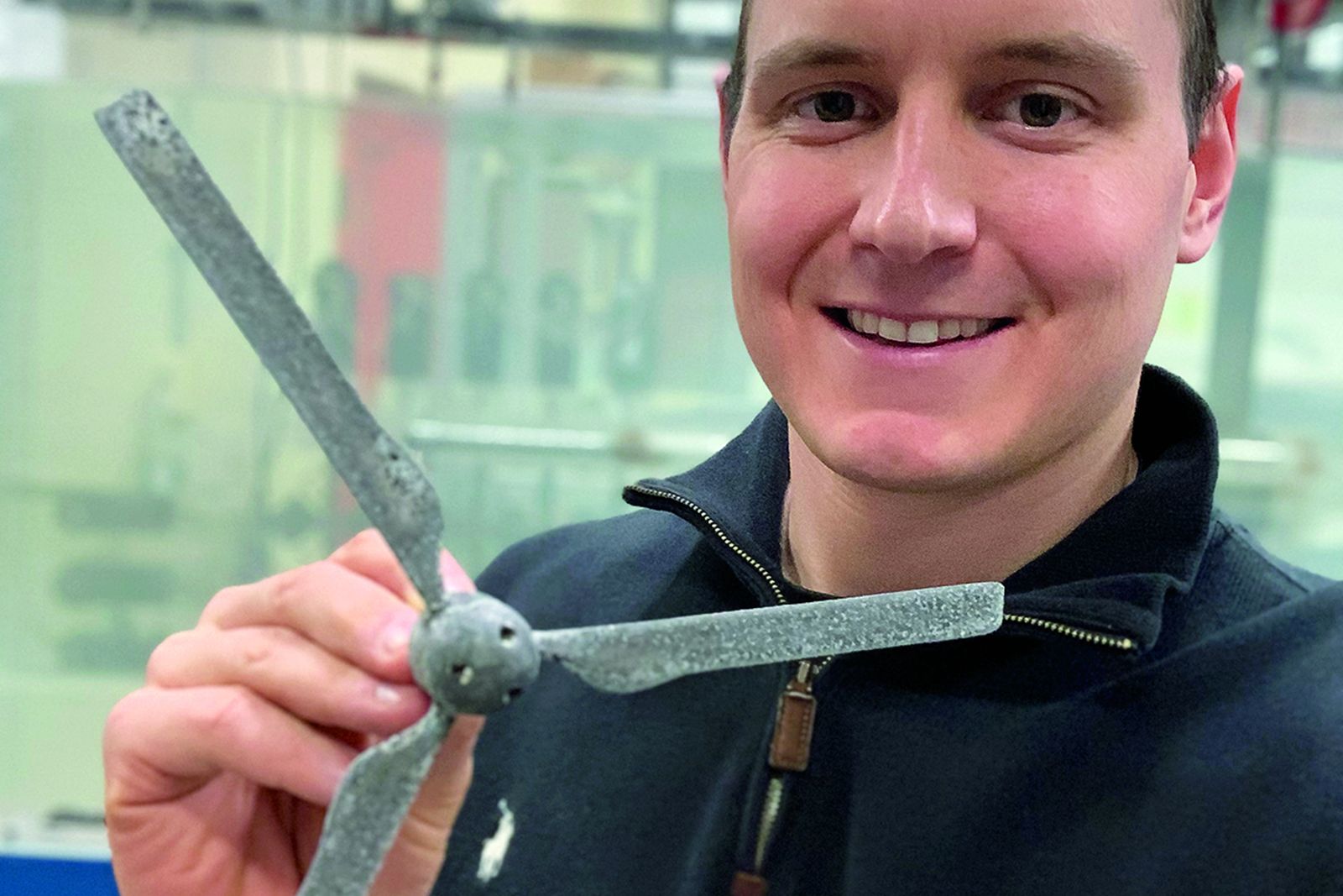 A Lehigh mechanical engineering researcher holding a set of small turbine blades