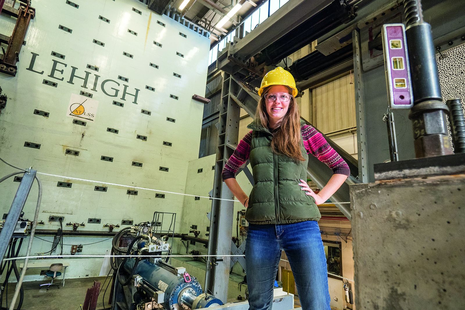 A Lehigh researcher in a hard hat at the multi-directional reaction wall of the ATLSS Engineering Research Center