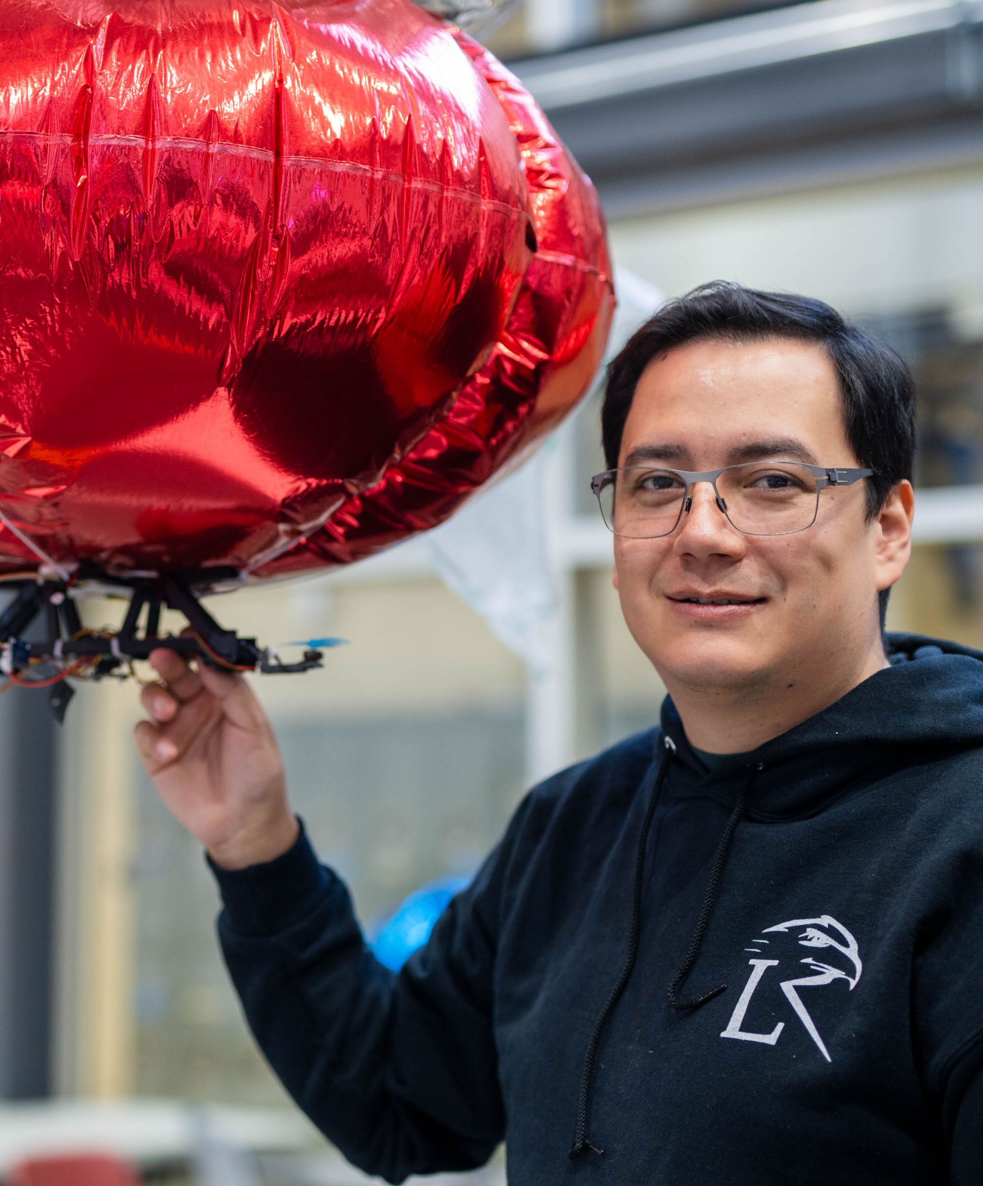 David Saldana holding robotic drone/blimp