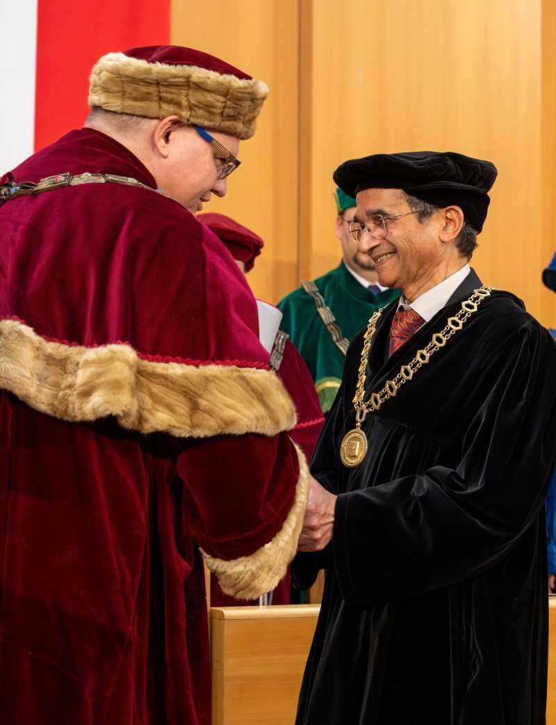 Himanshu Jain, right, receives his honorary doctorate