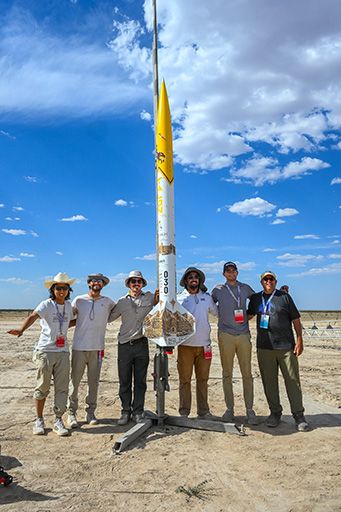 LURA team poses with rocket out in the desert
