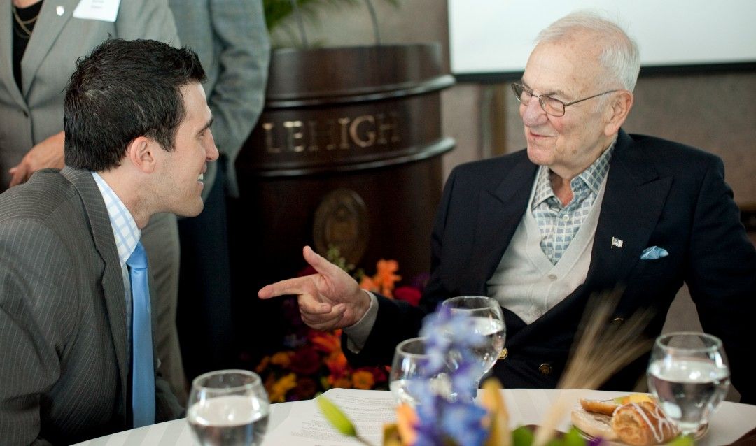 Lee Iacocca '45 speaks with a participant in the Global Village.
