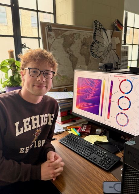 N. Dudko in front of computer with research data