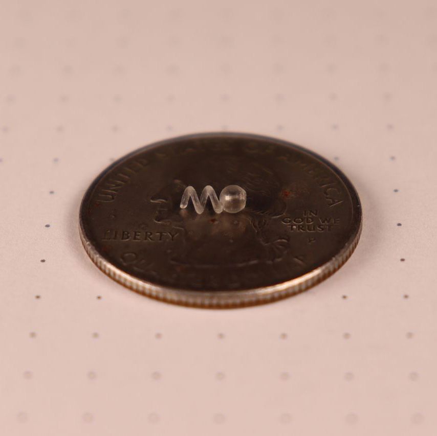Millimieter-scale robot swimmer with coin for scale. 