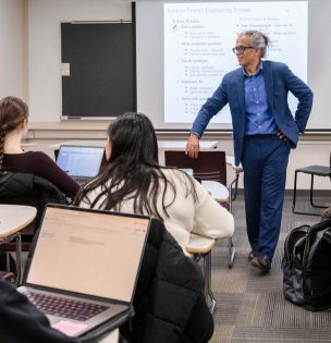 Bilal Khan, professor of biostatistics and health data science and professor in the Department of Computer Science and Engineering, listens to a student during one of his classes.