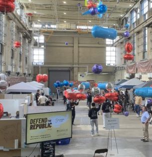 Drones with Mylar balloons compete in high bay in Building C