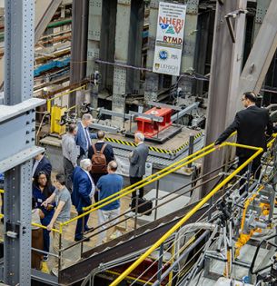 Visitors tour the ATLSS Engineering Research Center at Lehigh University, viewing large-scale structural testing equipment during the center’s 40th anniversary celebration.