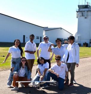 LU Aero outdoor team group shot with plane at 2024 AIAA Design/Build/Fly Flyoff