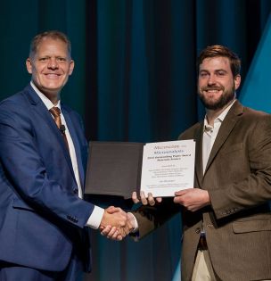 Professor Sean Mills accepts award from MSA President Grant Jensen. 