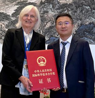 Dr. Reichmanis holding her award and Dr. Gang Wang after the ceremony in Bejing