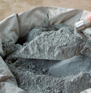 stock image of cement powder in bag with trowel