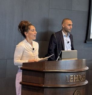 Farrah Moazeni and Javad Khazaei presenting at lectern during a symposium 