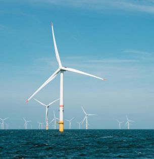 offshore wind turbines against blue sky