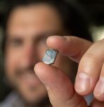 Siddha Pimputkar closeup of hand holding crystal