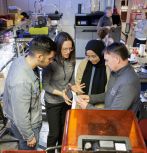 Faculty and graduate students in an additive manufacturing lab