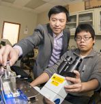 Assistant professor Frank Zhang (standing) with Ph.D. candidate Yan Xu (Photo by Ryan Hulvat / Lehigh University)