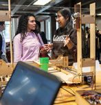 Students discuss a machine that was built in the FYRE program