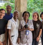 The Artificial Intelligence Strengthening Healthcare Acess (AISHA) team passes an Alexa device to a health care provider in Sierra Leone.