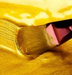 paintbrush with flowing yellow gold paint; Subbotina Anna/Adobe Stock