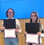 Student poster competition winners holding awards
