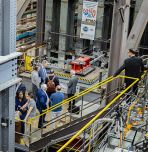 Visitors tour the ATLSS Engineering Research Center at Lehigh University, viewing large-scale structural testing equipment during the center’s 40th anniversary celebration.