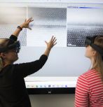 Dr. Caro Reidel, postdoctoral research associate in the materials science and engineering department, and Mari-Therese Burton, Presidential NHI Scholar and graduate research associate in the materials science and engineering department, demonstrate the use of Microsoft HoloLens 2 mixed-reality headsets in Lehigh's NHI Lab. 