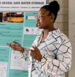 Woman student presenting at STEM-SI poster session