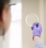 Woman holding petri dish