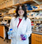 Lillian Wu ’27 holding laboratory equipment in wet lab