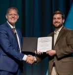Professor Sean Mills accepts award from MSA President Grant Jensen. 