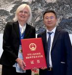 Dr. Reichmanis holding her award and Dr. Gang Wang after the ceremony in Bejing