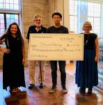 Shen Wang and supporters holding ceremonial check
