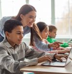 Students and their teacher working with educational technologyin a classroom