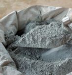 stock image of cement powder in bag with trowel