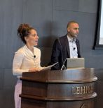Farrah Moazeni and Javad Khazaei presenting at lectern during a symposium 