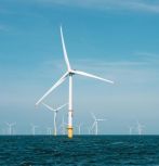 offshore wind turbines against blue sky