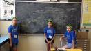 Girls in front of chalkboard