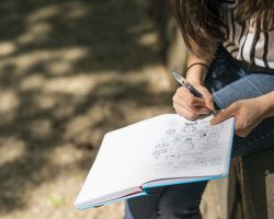 Graduate student with inventor's notebook